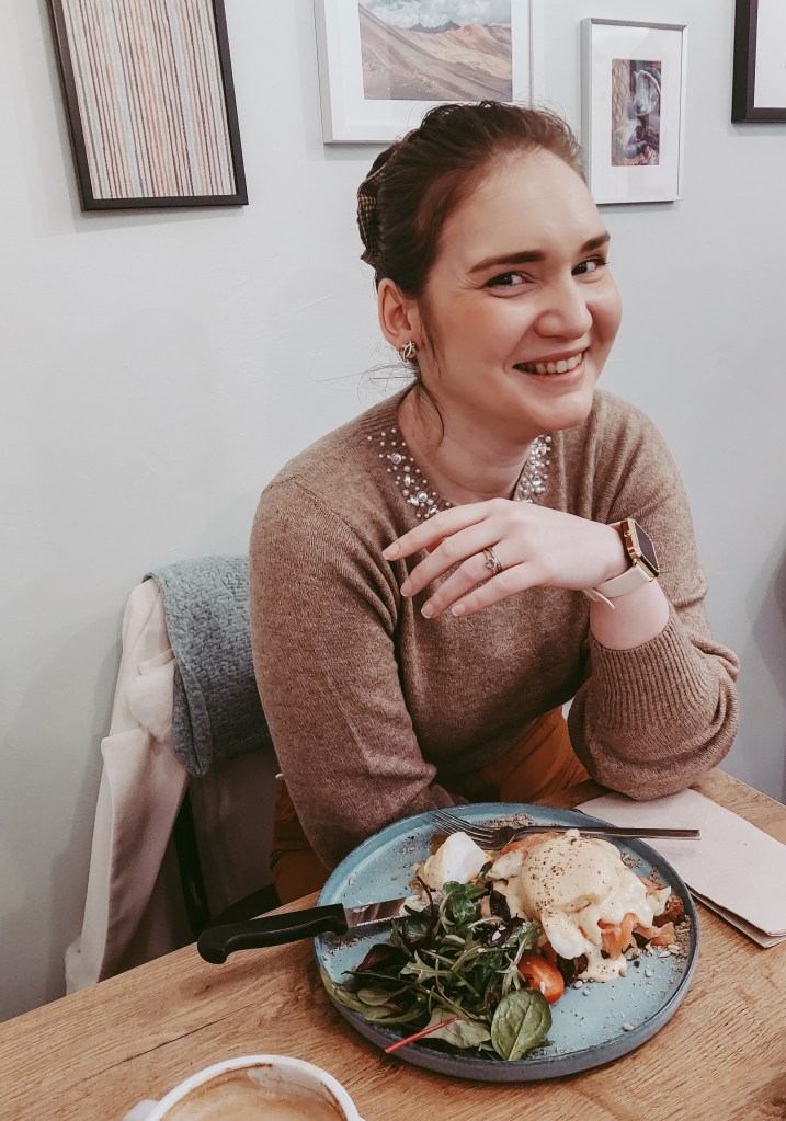 The author sitting at a table during brunch at Café Mama Silvia in Hamburg.