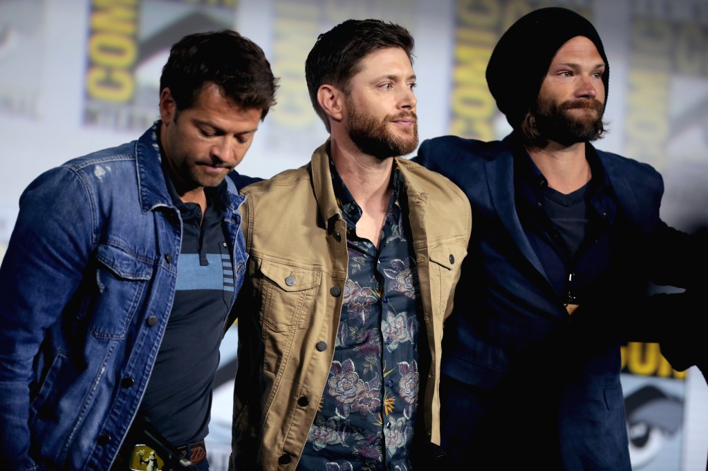Misha Collins, Jensen Ackles and Jared Padalecki on stage at the Supernatural panel at San Diego Comic-Con, 2019.